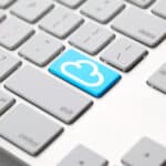 a keyboard with a blue cloud button on it