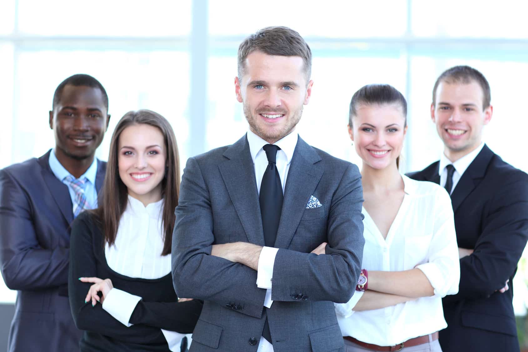 a group of business people standing in front of a window