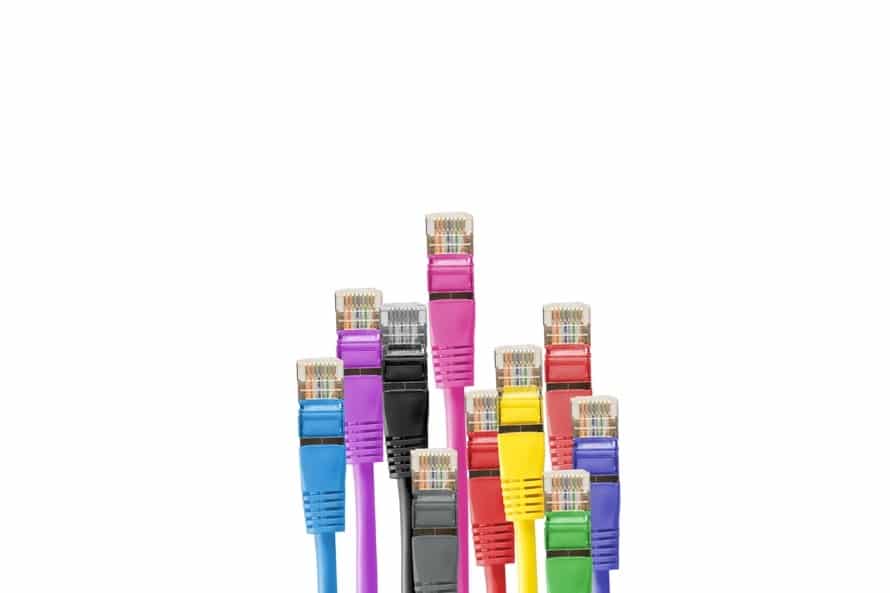 a group of multicolored ethernet cables sitting next to each other