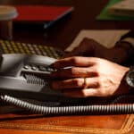 a person using a phone at a desk