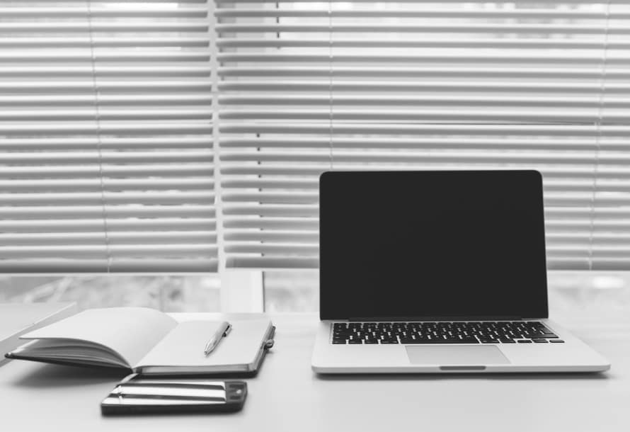 a laptop computer sitting on top of a desk