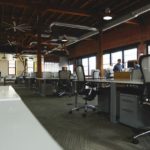 an empty office with people working at their desks