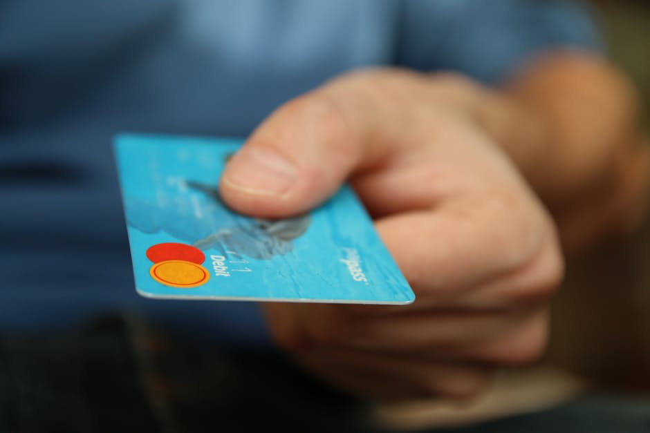 a person holding a credit card in their hand