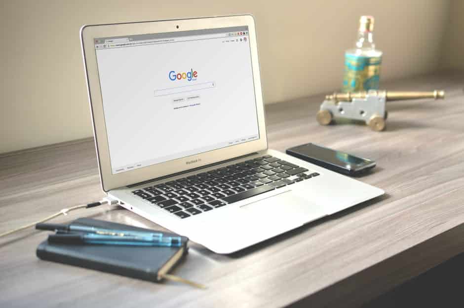 a laptop computer sitting on top of a wooden desk