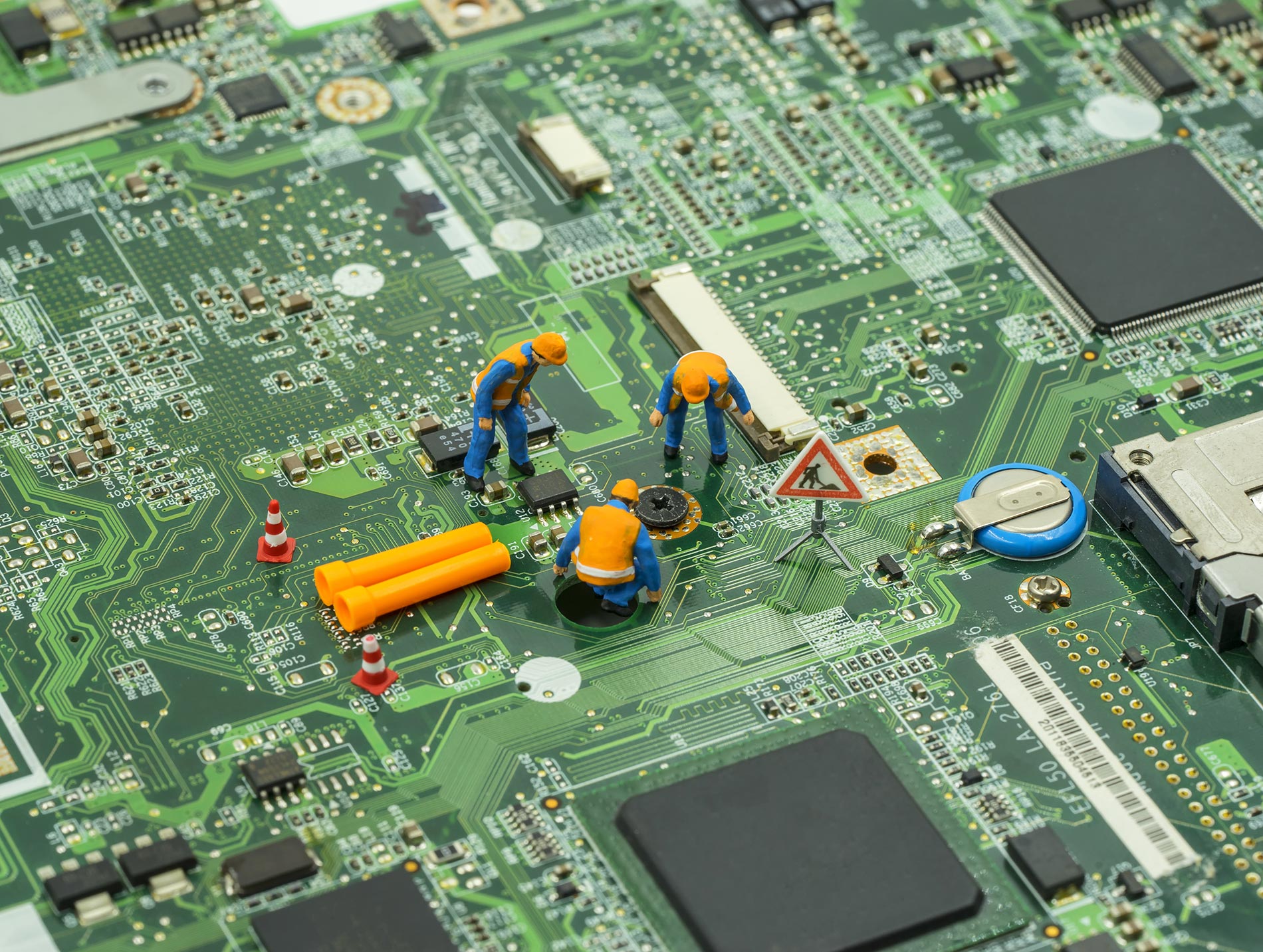a close up of a computer motherboard with some tools on it