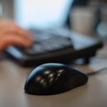 a person using a computer mouse and keyboard