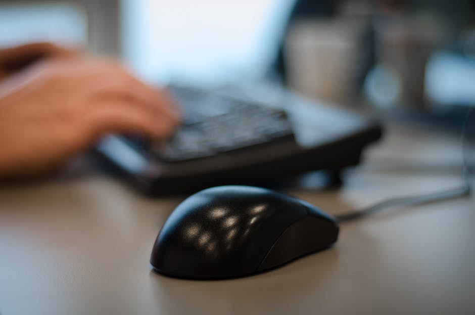 a person using a computer mouse and keyboard