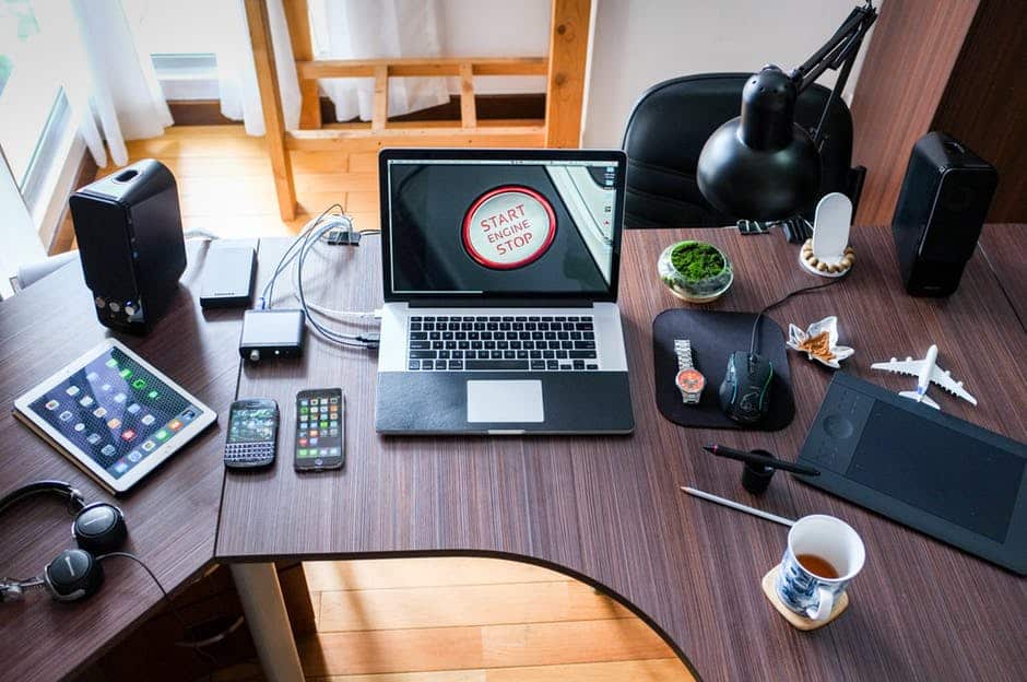 a laptop computer sitting on top of a wooden desk