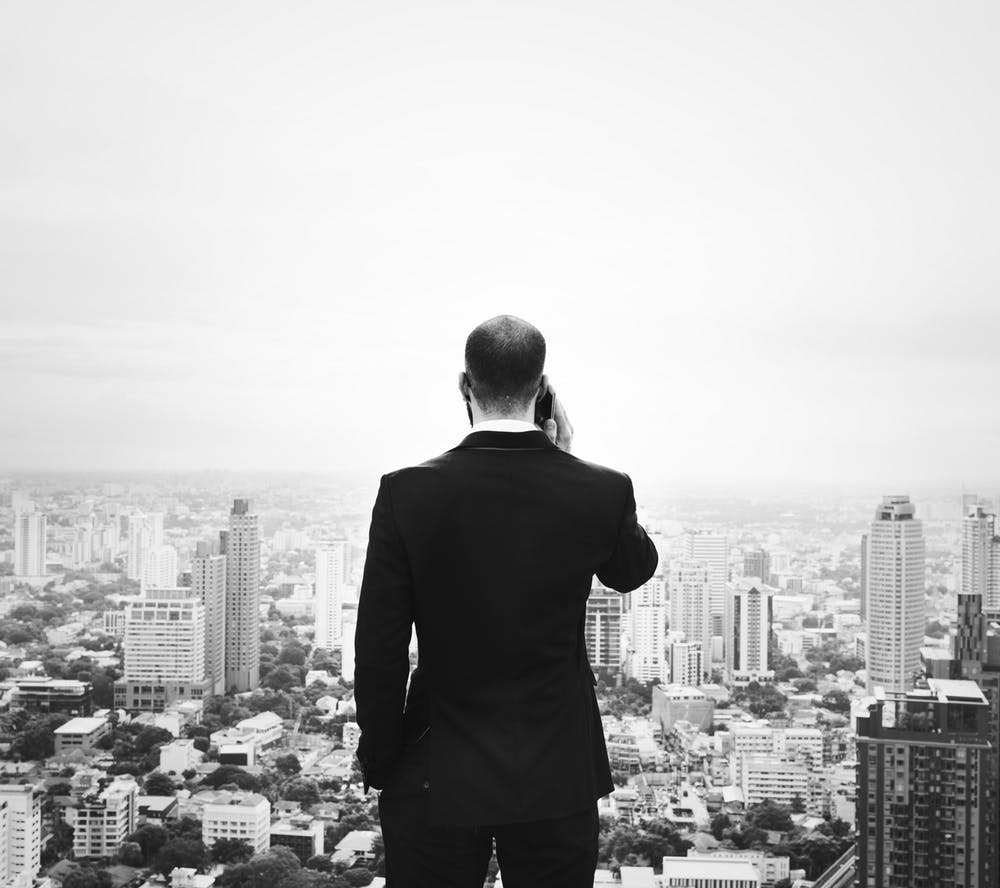 a man standing on top of a tall building