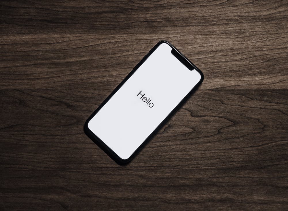 an iphone with the word hello written on it