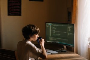 a person sitting at a desk in front of a computer