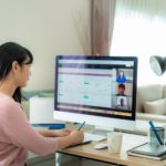 a woman sitting at a desk in front of a computer