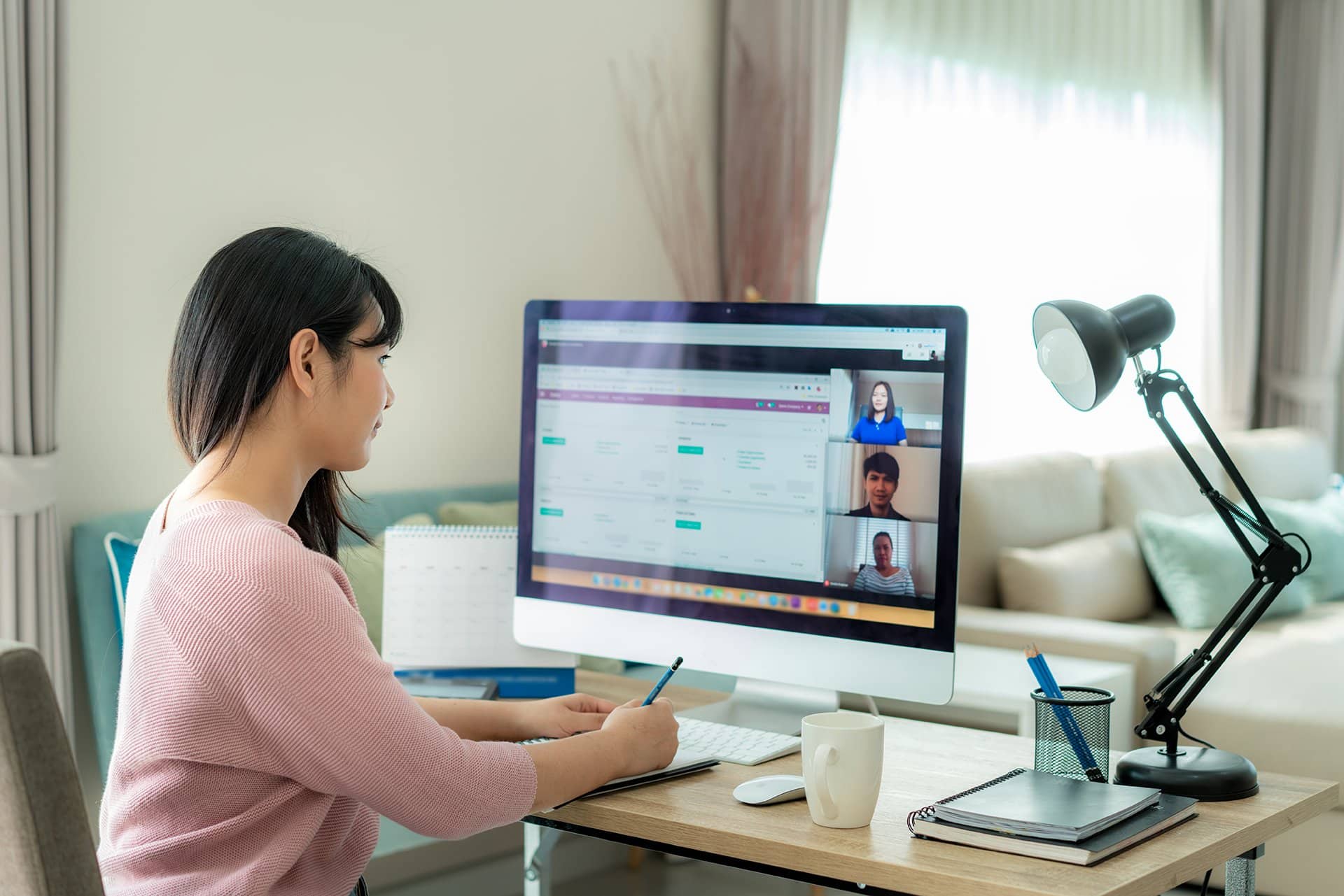 a woman sitting at a desk in front of a computer