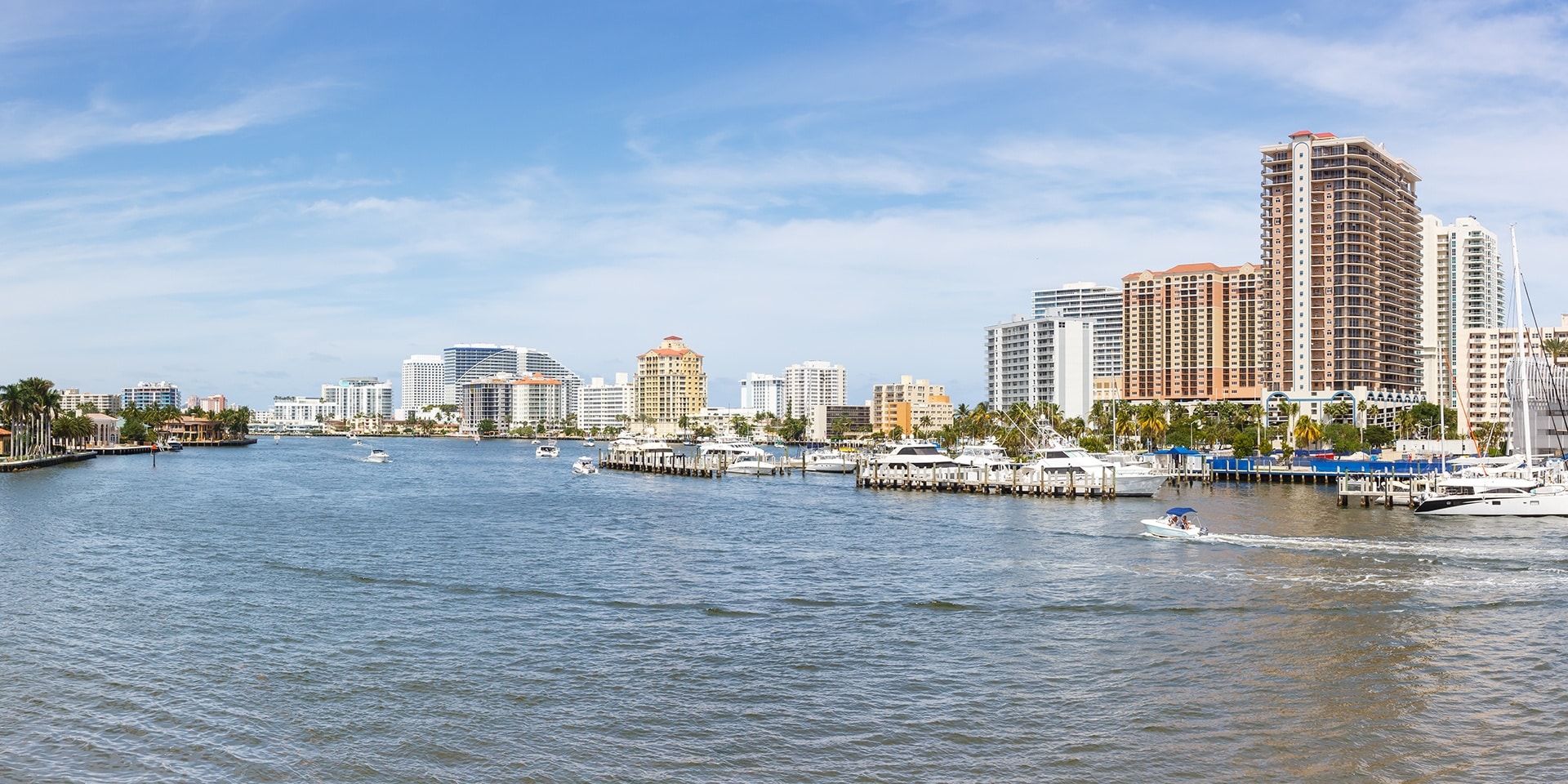 a harbor filled with lots of boats next to tall buildings