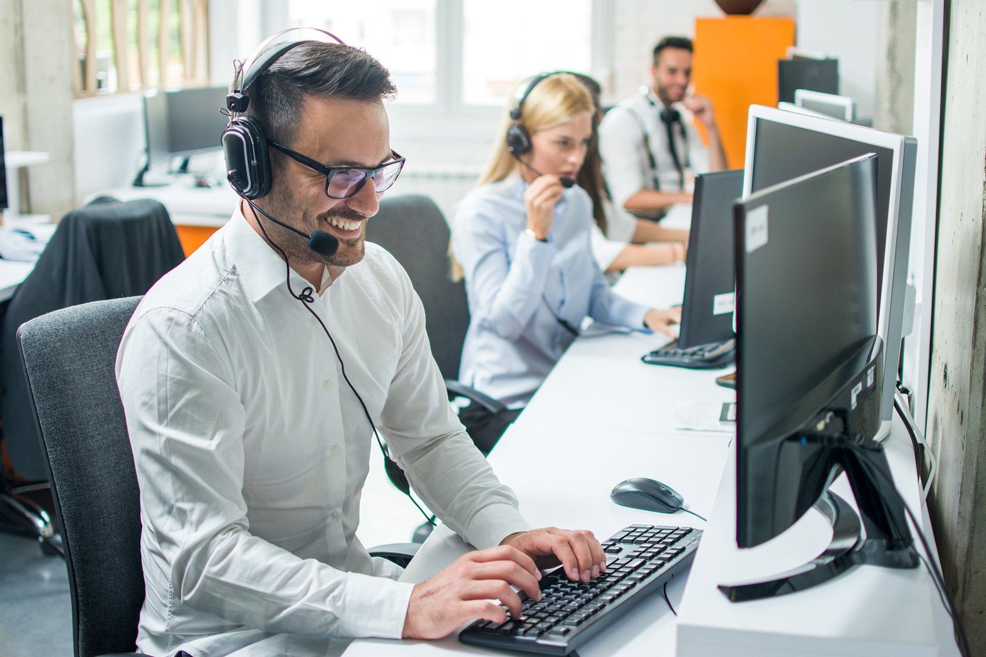 a man wearing headphones and using a computer