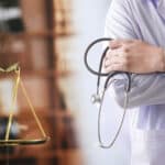 a doctor holding a stethoscope next to a scale